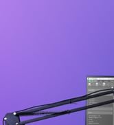 Partial view of a metallic device with black handles against a purple background, possibly a kitchen or styling tool.