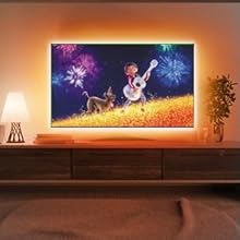 a television with a cartoon dog playing guitar and a man playing guitar.