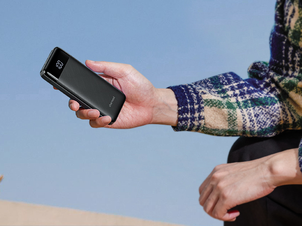 a person holding a cell phone in their hand.