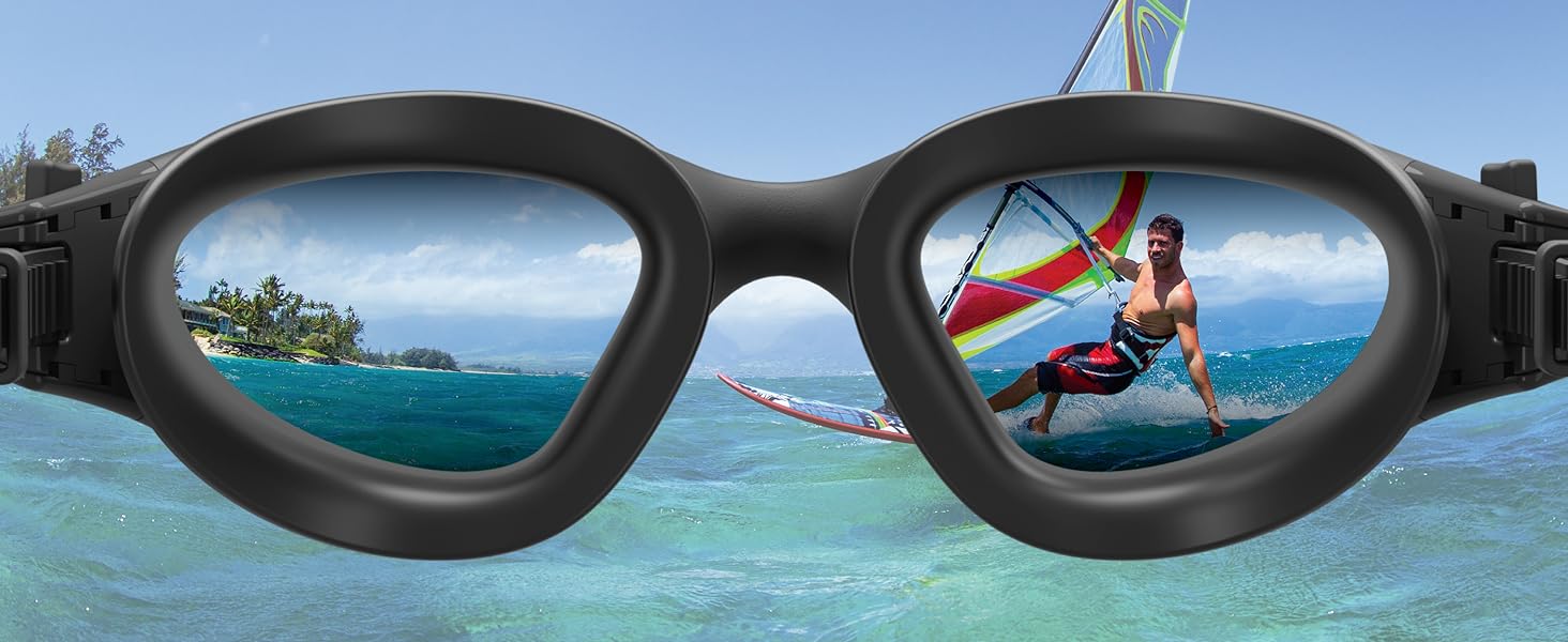 Swimming goggles with tinted lenses reflecting beach and water sports scenes, showcasing their use in aquatic activities.