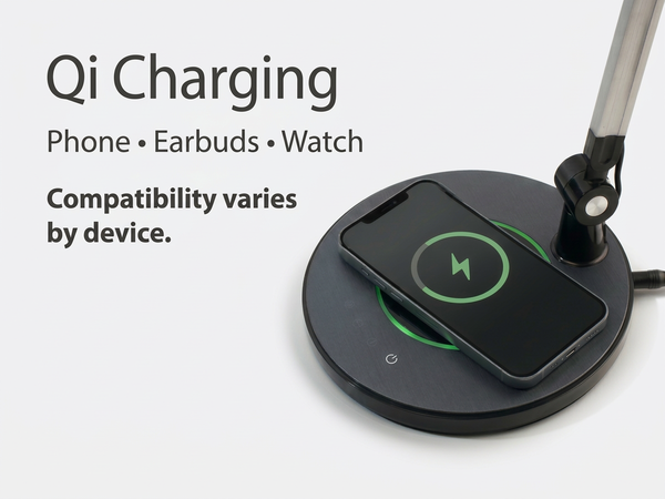 LED desk lamp with built-in wireless charging base charging a smartphone on the desk