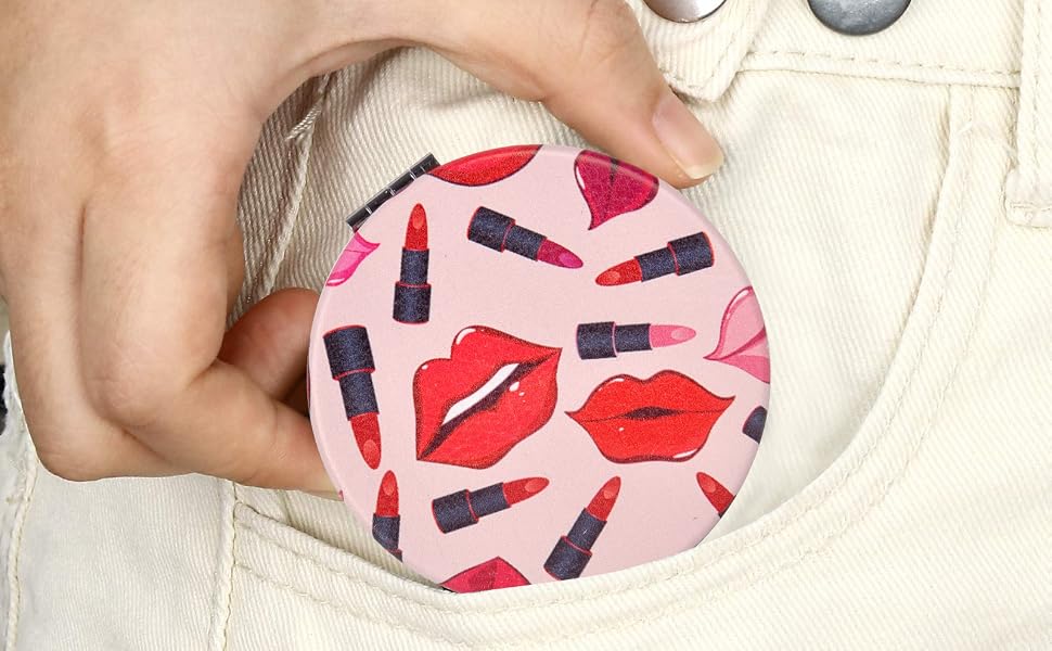 Text reads 'PORTABLE POCKET MIRROR'. Hand holding circular mirror with red lip print pattern design, displayed with pocket-sized compact mirror component.