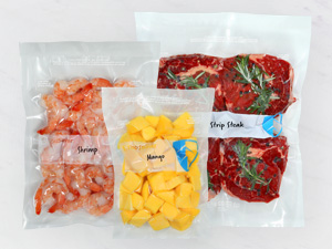 Vacuum-sealed shrimp, mango, and steak in clear bags