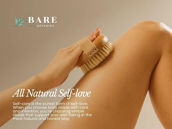 woman dry brushing their leg with a dry brushing body brush