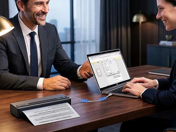 Professional setting showing digital tablet and documents on dark wooden desk, with people in business attire collaborating over the materials.