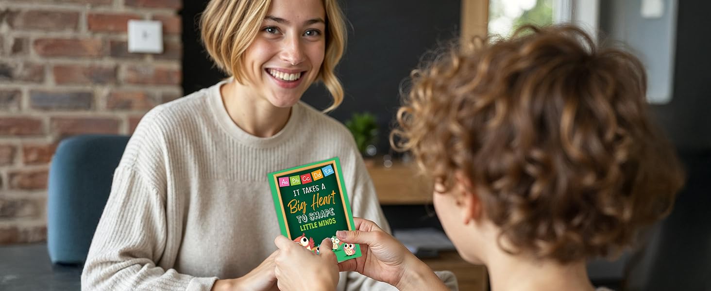 A smiling teacher receives thank you card for teacher from a student in a heartfelt moment.