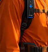 Close-up of orange and black textured fabric material, appears to be part of clothing or gear with layered construction.