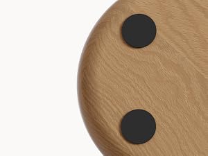 Close-up shots of tan textured surface with two black circular dots or markers, shown from different angles.