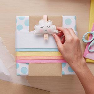 Rainbow baby gift wrap made of layers of tissue paper in pink, orange, yellow, blue and white
