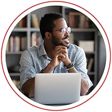man sitting in front of laptop smiling