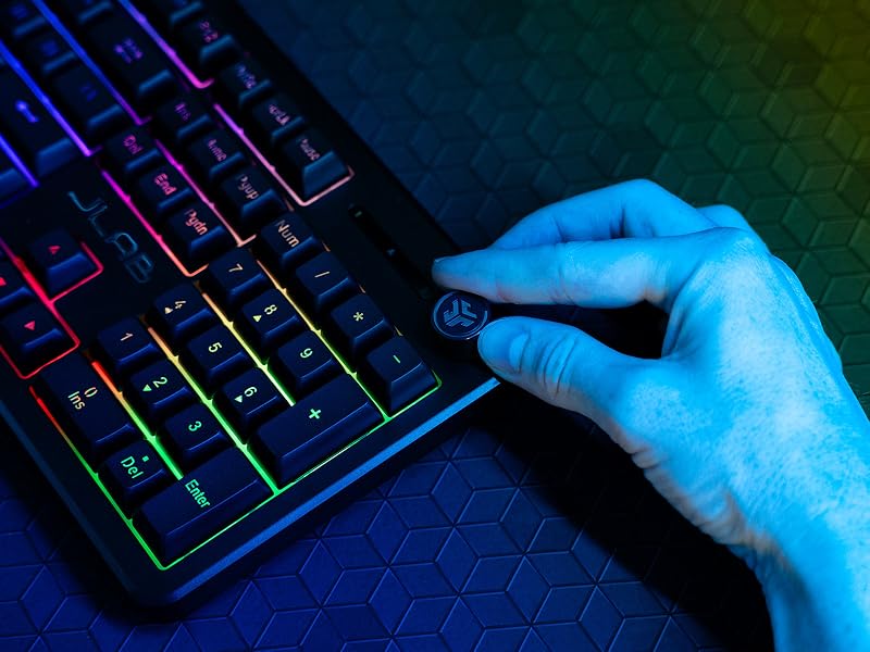 A hand twisting the media dial on the corner of the nightfall keyboard