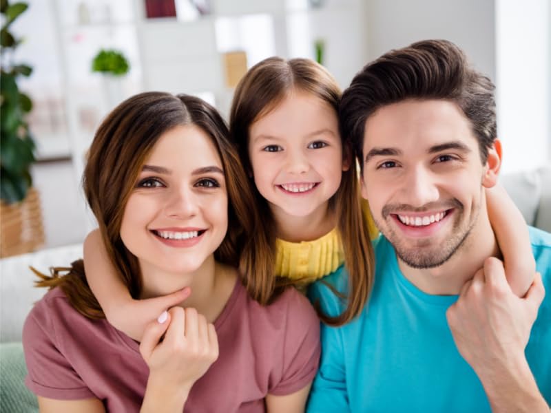 Father, mother and daught smiling with perfect white teeth