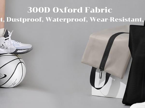 Lightweight, dustproof, waterproof tote bags made of 300D Oxford fabric. Shown in beige and black colors, with contrast handles and zippers. Basketball and tennis racket visible for context.