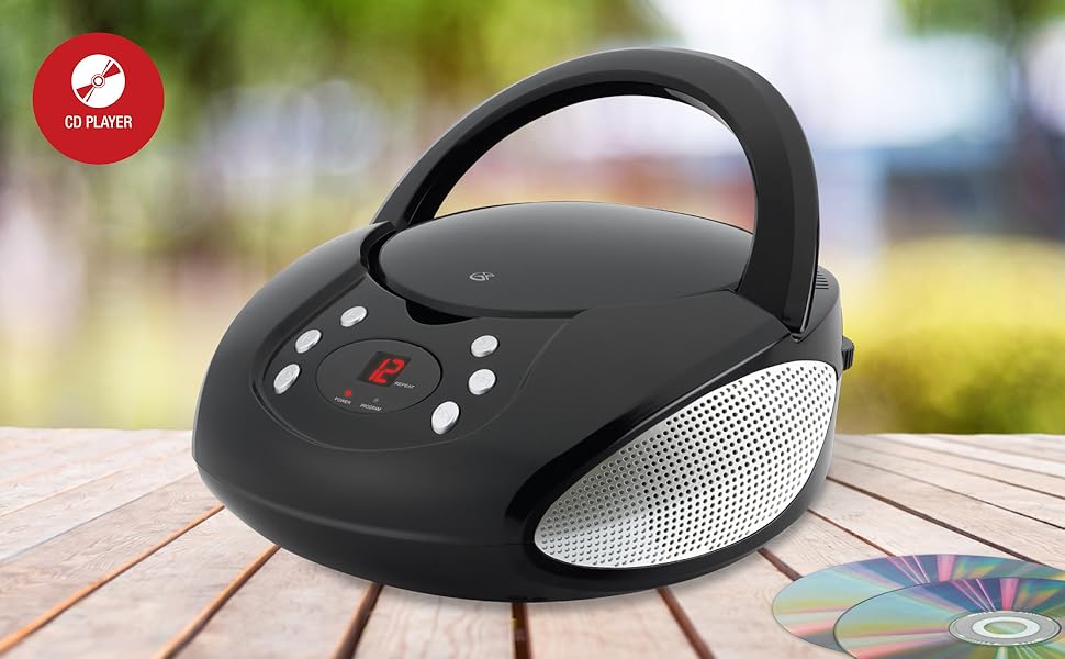 A black CD player on a wooden table outdoors with a red circle icon reading "CD Player."