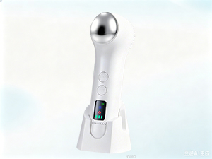 A face massager resting on its product box.