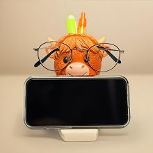 Highland cow phone stand holding smartphone horizontally