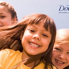 Portrait of three smiling young girls against a light blue background featuring a Dove logo.