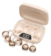 Beige case containing multiple small earpieces, charging components, and accessories. Wireless earbud set with storage case and various ear tip sizes for proper fit.