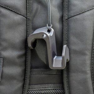 Fence Buddy hook clipped to a sports bag via paracord lanyard