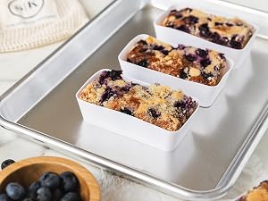 Designer white silicone baking cups with baked blueberry crumble