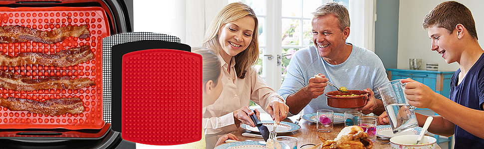 family enjoying dinner around table after cooking with air fryer reusable mats