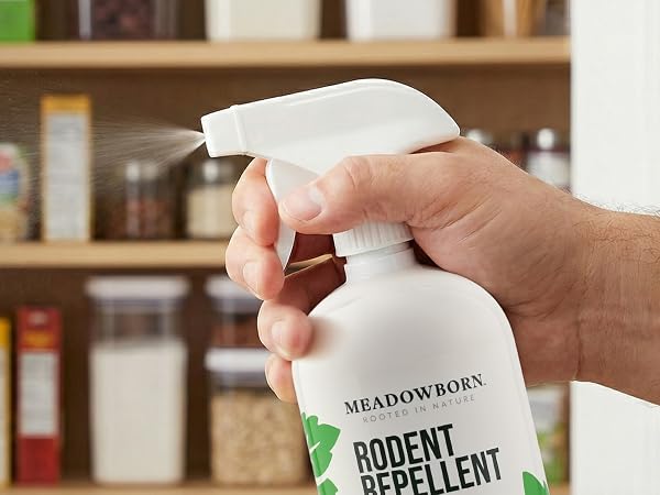 Action shot of a hand firmly gripping the ergonomic trigger of the bottle.