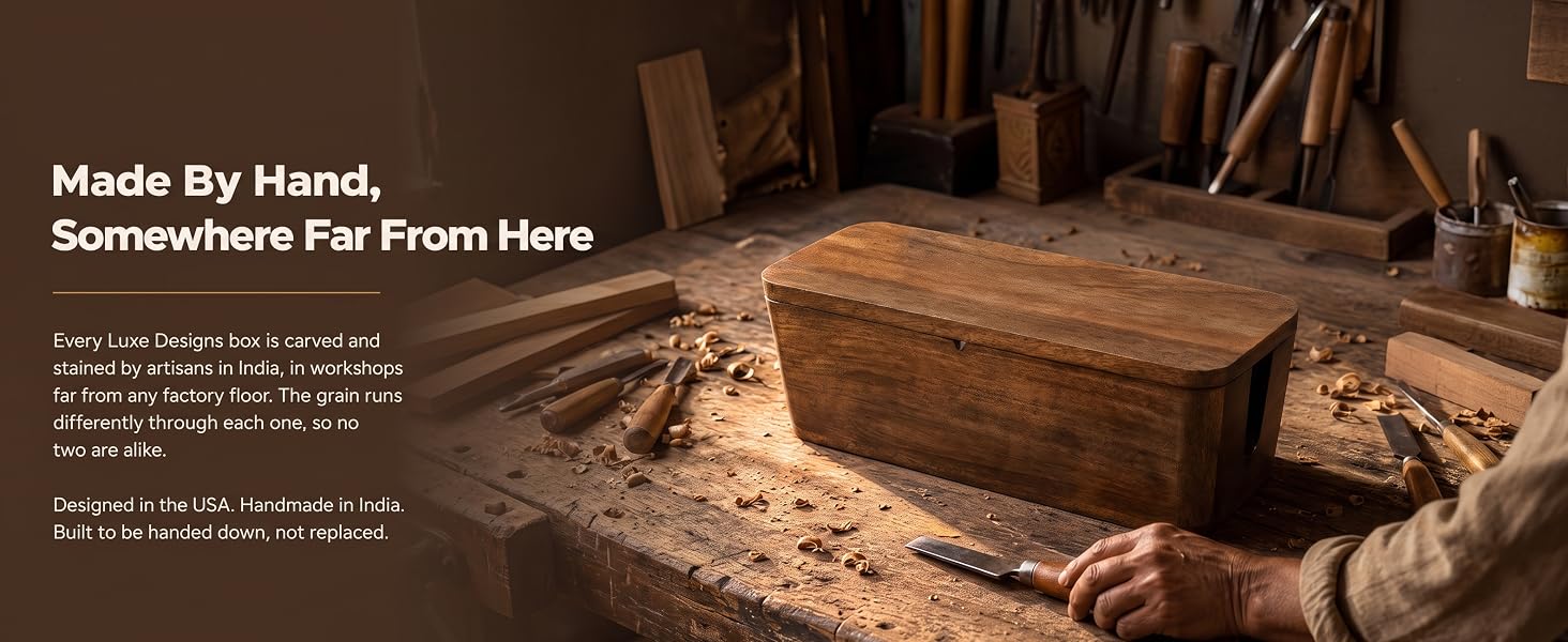 Hands finishing a solid mango wood cable box, showing carved grain and stain