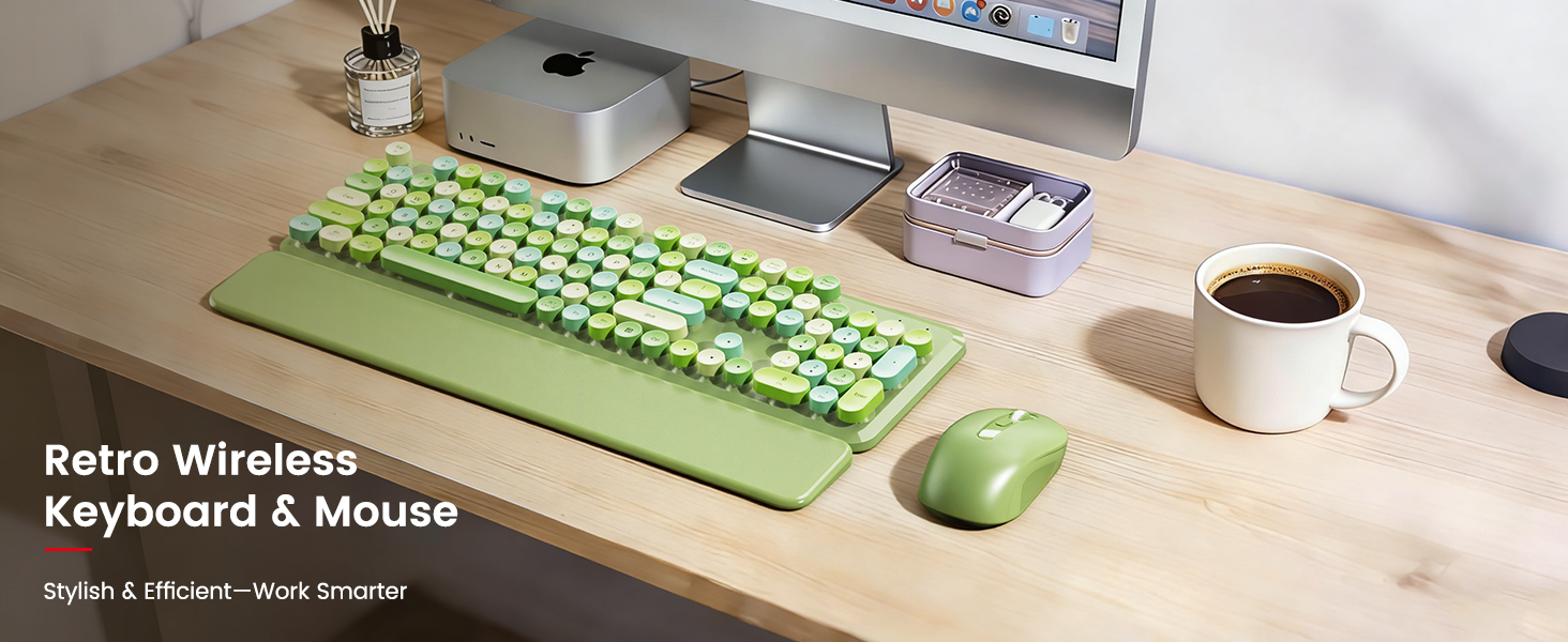 Green retro keyboard and mouse with wrist rest on a clean wooden desk setup