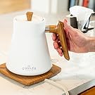 Woman's hand on wood ergonomic kettle handle
