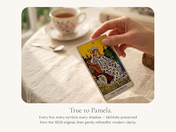 Hand holding The Empress card from the Dionysus Classic Tarot Deck beside a teacup.