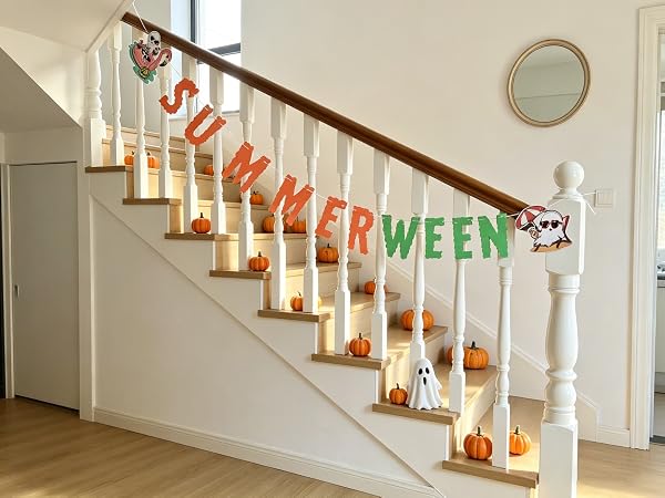 Banner tied to balusters, spooky summer decor for hallway.