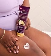 Woman rubbing lotion onto her leg