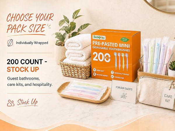 TuckPoki 200-count prepasted toothbrushes arranged for guest bathrooms and care kits.