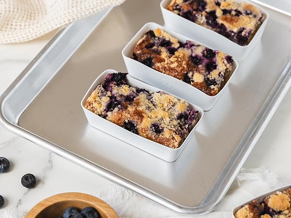 Rectangle silicone baking cup with a blueberry crumble on a baking sheet