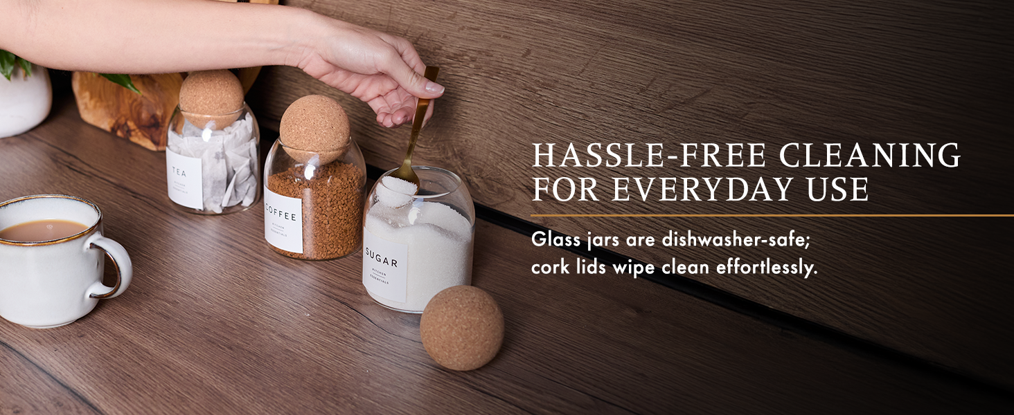 Tabletop scene with glass jars, coffee cups, and wooden objects. Text overlay reads 'HASSLE-FREE CLEANING FOR EVERYDAY USE' and mentions dishwasher-safe properties.