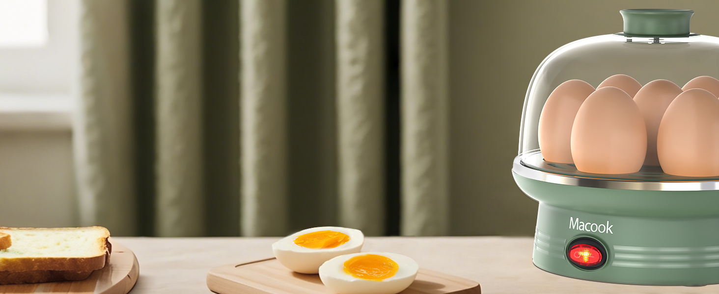 Egg cooker with pale green base and clear dome lid, containing brown eggs. Nearby wooden board displays sliced bread and cooked eggs with visible yolks.