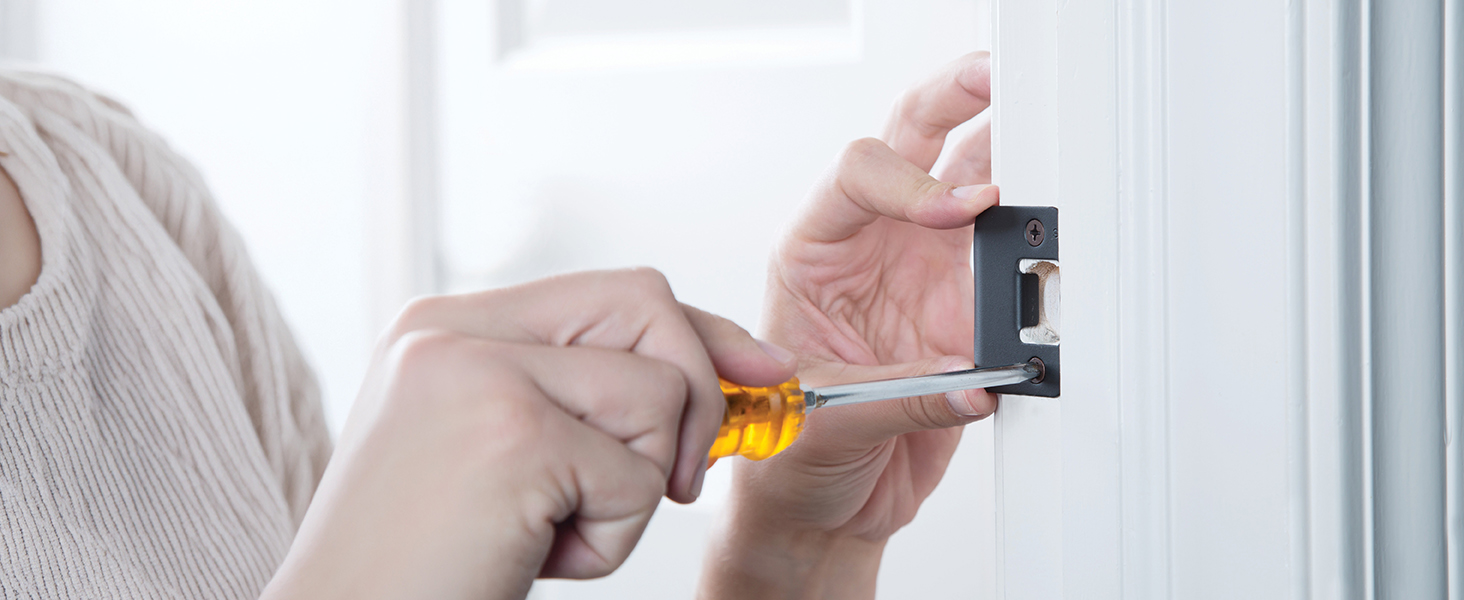 Woman easily installing door hardware for handle, knob or lever with just a screwdriver