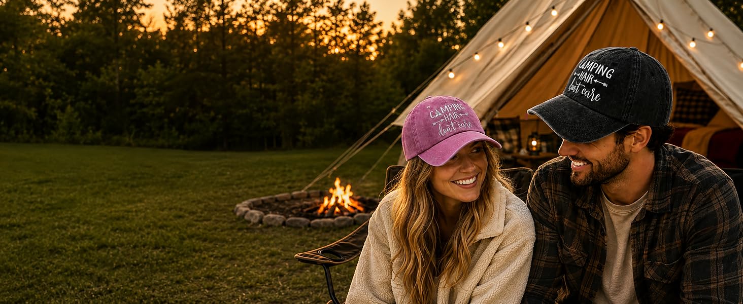Couple at sunset campsite wearing embroidered Camping baseball caps near campfire and canvas tent