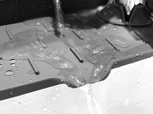 sink drain mat behind faucet