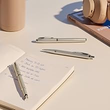 Parker IM Monochrome ballpoint pens on desk with notebook