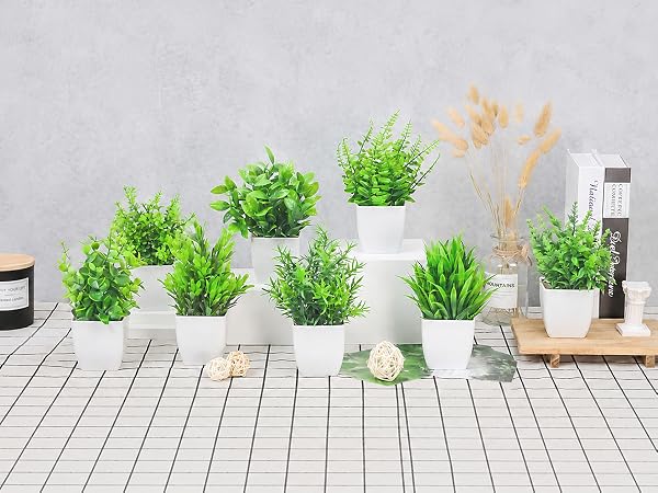eight artificial green plants white pots tabletop display