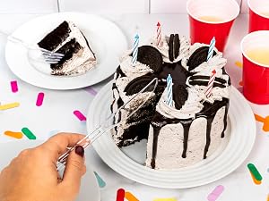 Plastic knife cutting into a birthday cake.