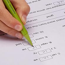 Green barrel pencil filling in test answers