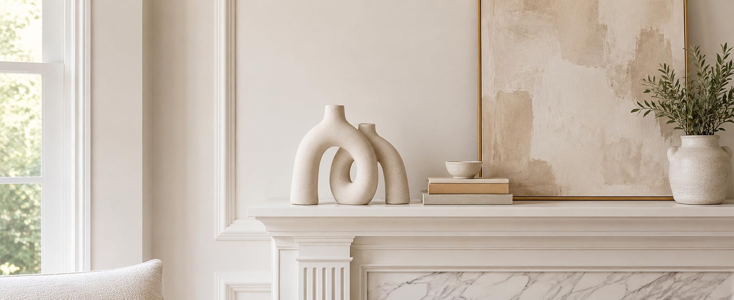 Cream ceramic donut vase displayed on a white fireplace mantel with neutral wall art