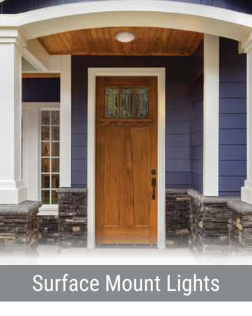Emergency light above double push-bar exit doors in a commercial or institutional setting.