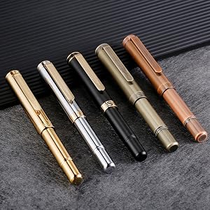 5 EDC pens in a row on a table top. Gold, Silver, Black, Brushed gold and Copper