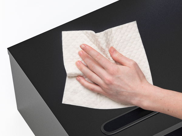 a person's hand is cleaning a paper towel.