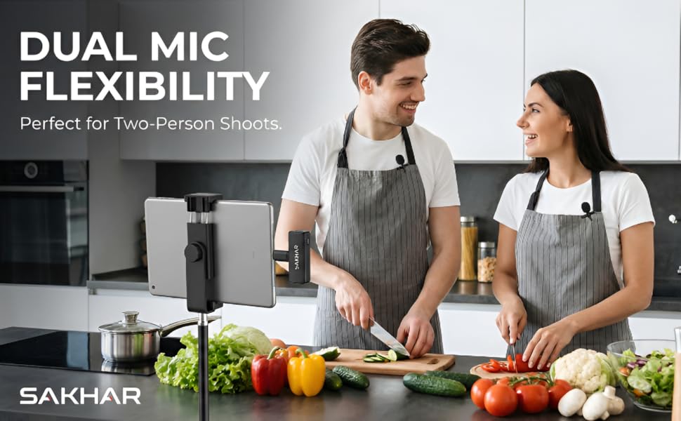 Two people wearing SAKHAR wireless microphones while recording a video together in a kitchen setting
