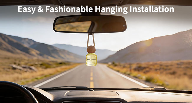 Text reads: 'Easy & Fashionable Hanging Installation'. Car interior view through windshield showing air freshener hanging from rearview mirror, with mountainous road ahead.