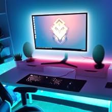 a computer desk with a monitor and a chair